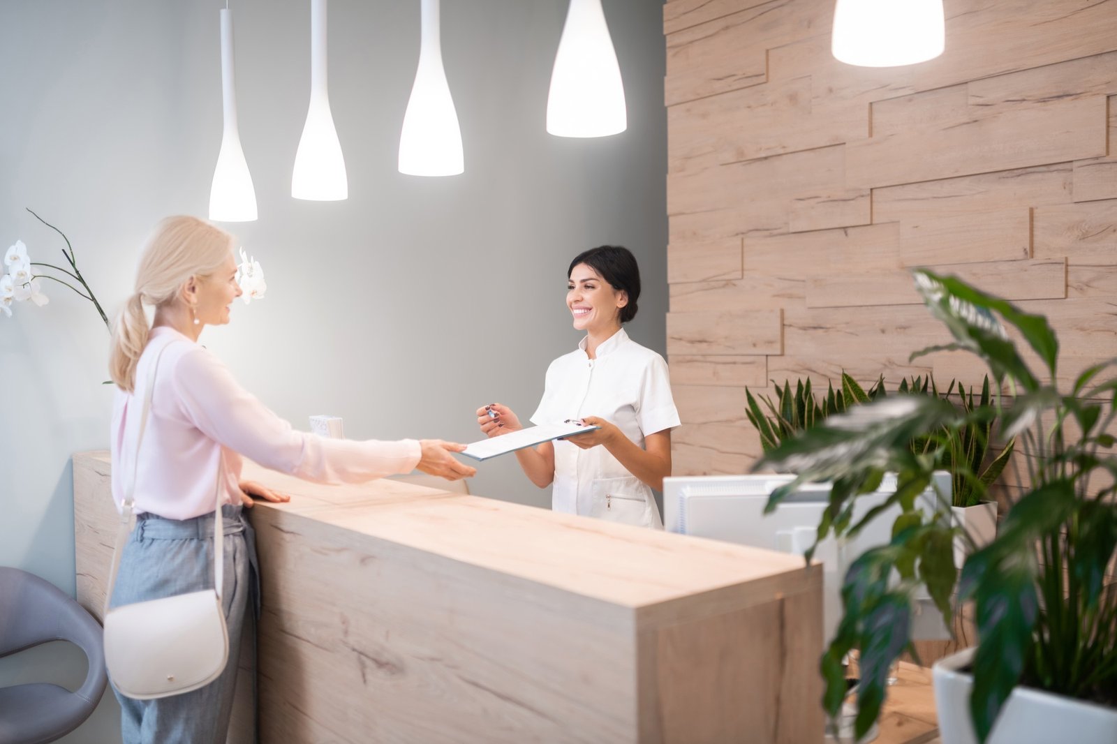 Woman standing at reception of dental clinic